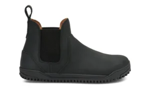 A black slip-on Chelsea Boot by Xero Shoes featuring elastic side panels, a pull tab at the back, rounded toe, and textured rubber sole. This simple design features visible stitching and a low heel—ideal for everyday styles.